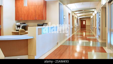 Empty Corridor And Nurse Station Desk In Modern Hospital Building Stock Photo