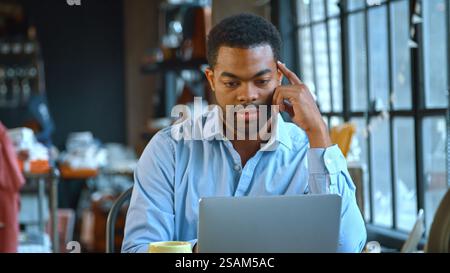 Male Fashion Designer In Creative Industry Sitting At Desk Using Laptop In Studio Stock Photo