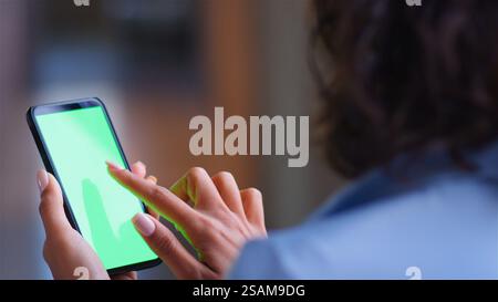 Over The Shoulder Close Up Shot Of Businesswoman Using Green Screen Mobile Phone Stock Photo