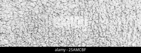 A detailed close-up of soft white textured fabric with a fluffy, looped pattern, ideal for stock use in textile, comfort, and interior design themes Stock Photo