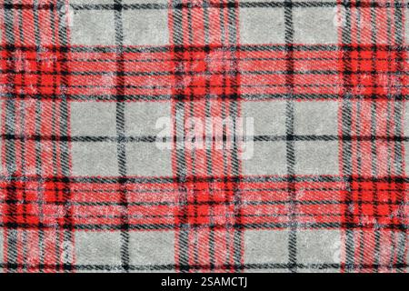 Close up of red and black crumpled tartan plaid fabric with gray background. Perfect for fashion, textile, or pattern design projects Stock Photo