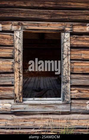 Window in the old Osborn log cabin, Wind River Range, Wyoming. Stock Photo