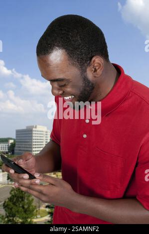 Black African American man using a cell phone for texting Stock Photo