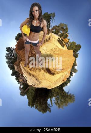 Woman Construction Worker on a job site wearing a hard hat Stock Photo