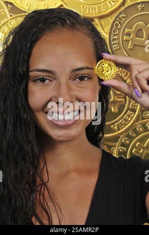 Woman holding the Electonic Currency known as Bitcoin Stock Photo