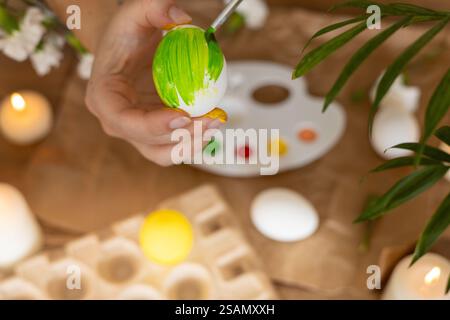 Springtime egg painting activity celebrates Easter with vibrant colors and creativity Stock Photo