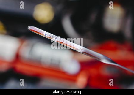 Metal dipstick showing oil level used for engine maintenance in automotive settings Stock Photo