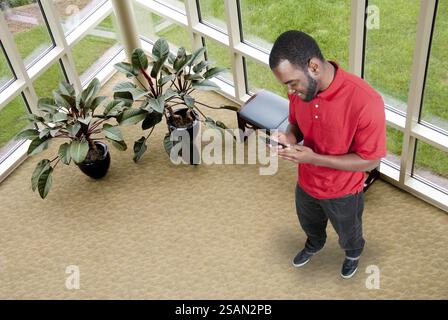 Black African American man using a cell phone for texting Stock Photo