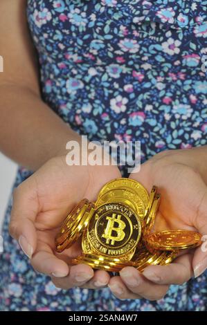 Woman holding the Electonic Currency known as Bitcoin Stock Photo