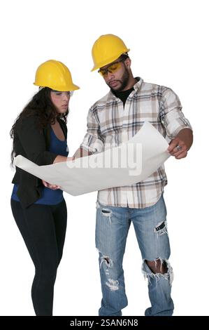 Construction Worker on a job site inspecting blueprints Stock Photo
