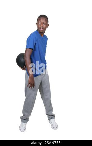 Handsome young black African American teenage man playing basketball Stock Photo