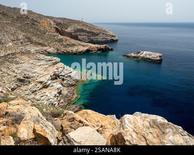 Deep Blue water on the rocky coast of Folegandros: The rough but beautiful and serene shoreline between Livadaki beach and the Aspropounta lighthouse. Stock Photo