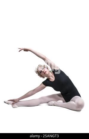Beautiful woman ballet dancer stretching before a performance Stock Photo