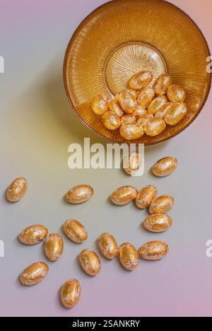 Gold foiled Easter eggs in a gold bowl; concept easter celebration. Stock Photo