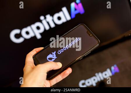 In this photo illustration the Capital AI logo is shown on two computer screens against the DeepSeek logo displayed on a mobile phone as China introdu Stock Photo