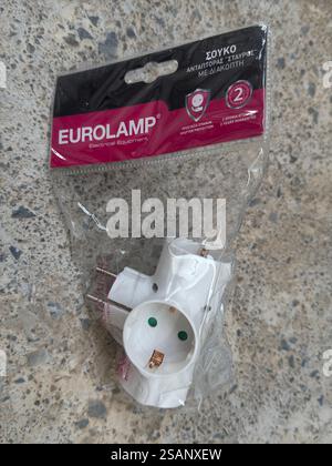 Close up of white electrical power plug adaptor cross to three sockets Stock Photo