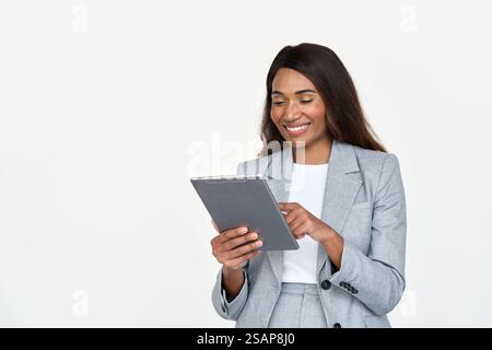 Happy busy African American business woman wearing suit using tablet. Stock Photo