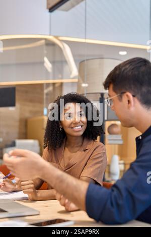 Diverse professional employees having conversation working together in office. Stock Photo