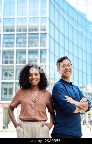 Portrait of young happy professional team of two diverse business man and woman. Stock Photo