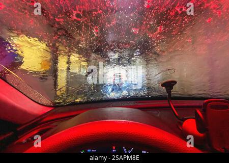 View from car interior of car being washed at car wash Stock Photo