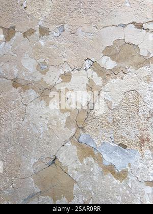 Cracked and Peeling Plaster Wall Texture, Weathered by Wind, Sea Moisture, and Scorching Sun Stock Photo