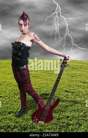 Beautiful woman punk rocker with an electric bass guitar Stock Photo ...