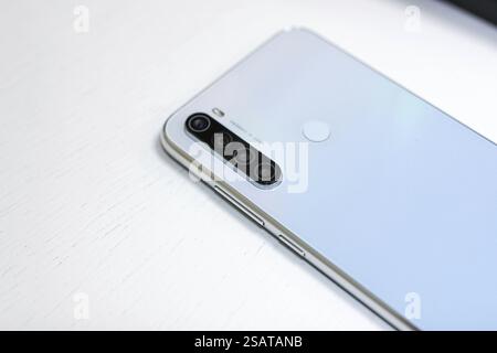 Close-up view of a silver smartphone with quad lenses Stock Photo