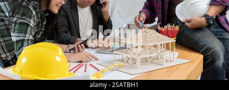 Data working and tablet laptop. Architect explaining project plan to clients. Group of an architect working and discussing about an architecture model Stock Photo