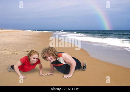 Young couple exercising by doing pushups together Stock Photo