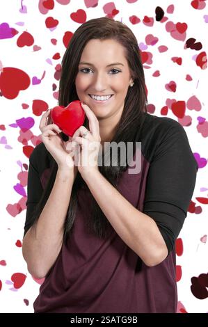 Beautiful young woman holding a Valentines Day heart Stock Photo - Alamy