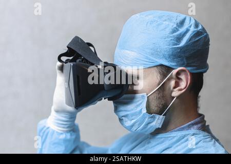 Medical professional using virtual reality goggles while wearing medical attire Stock Photo