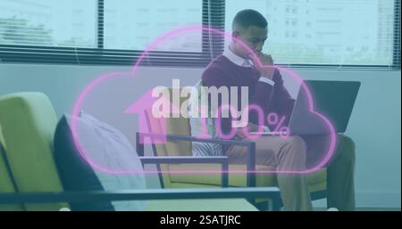 Image of cloud with percent growing over african american businessman using laptop Stock Photo