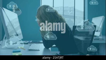 Image of clouds with percent growing over caucasian businesswoman using computer Stock Photo