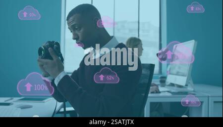 Image of clouds with percent growing over african american businessman using camera Stock Photo