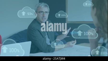 Image of clouds with percent growing over caucasian businessman using tablet Stock Photo