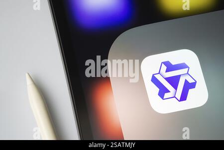 A close up of an iPad screen displaying the Alibaba Qwen AI Stock Photo