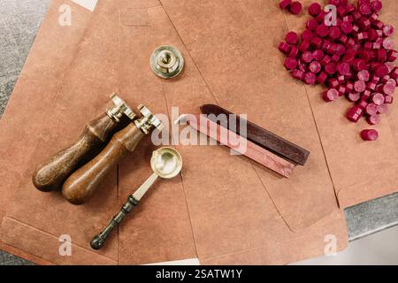 Wax seal set with red pellets and brown envelopes on table Stock Photo