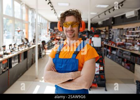 Portrait of seller in protective gears over hardware store interior Stock Photo