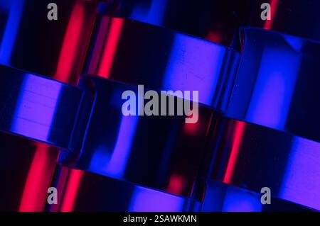 Abstract bands of red and blue light on a dark shiny surface Stock Photo