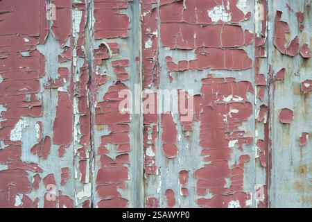 red old peeling wooden paint on a wall Stock Photo