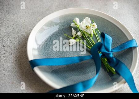 Table setting with snowdrops and ribbon Stock Photo