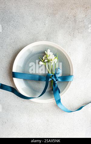 Table setting with snowdrops and ribbon Stock Photo