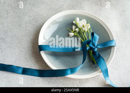 Table setting with snowdrops and ribbon Stock Photo
