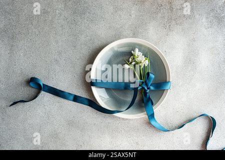 Table setting with snowdrops and ribbon Stock Photo
