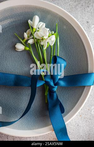 Table setting with snowdrops and ribbon Stock Photo