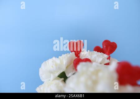 Candy Hearts in White Carnation Bouquet with Copy Space Stock Photo