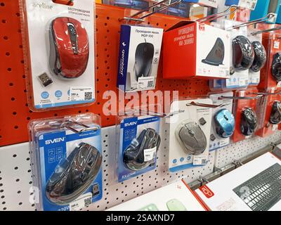 Assorted computer mice displayed on store shelves in retail packaging. Stock Photo