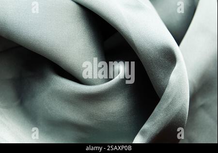 Soft light grey silk fabric with delicate folds and smooth texture. Stock Photo