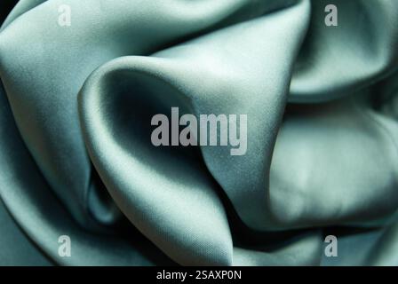 Soft light grey silk fabric with delicate folds and smooth texture. Stock Photo