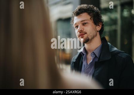 Young professional engaged in outdoor business conversation Stock Photo